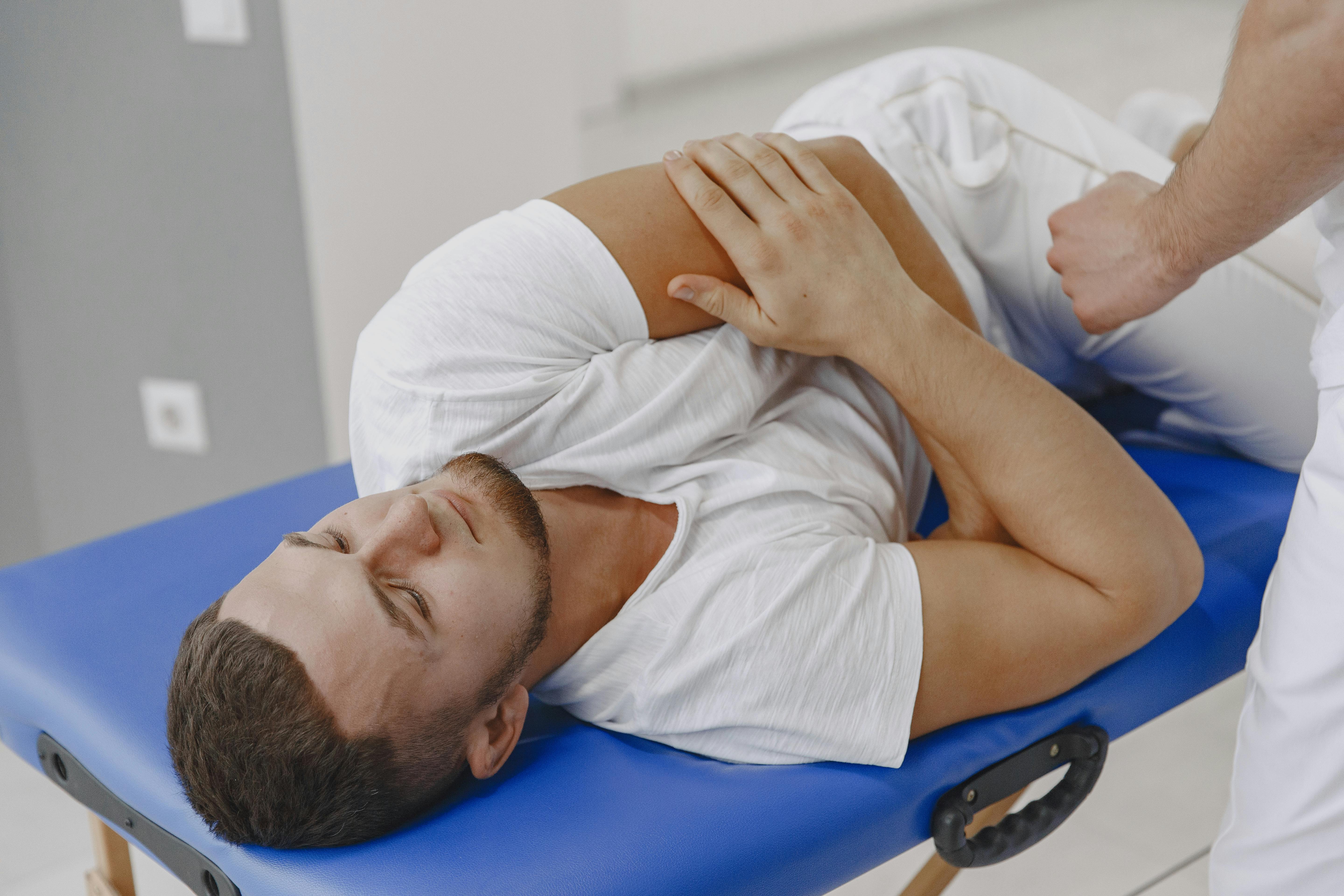 Chiropractor performing a shoulder and joint mobility assessment